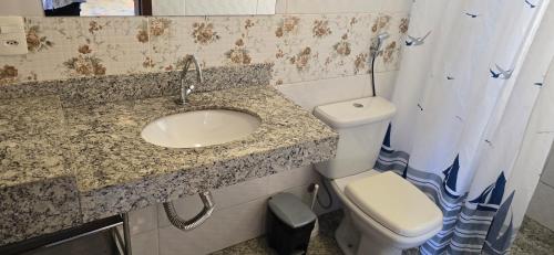 a bathroom with a sink and a toilet at Fazenda do Prata Ecoresort in Caratinga