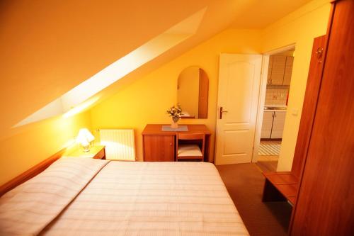 ein Schlafzimmer mit einem Bett und einem Schreibtisch sowie ein Zimmer mit einem 6 x 6 cm großen Bett. in der Unterkunft Tribunia Beach Hotel in Tribunj