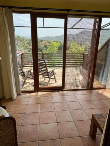 a room with a balcony with a view of the mountains at Mas del Bot in Valderrobres