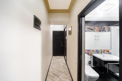 a bathroom with a toilet and a sink at 2-BDR/Perfect Location/Cozy in Yerevan