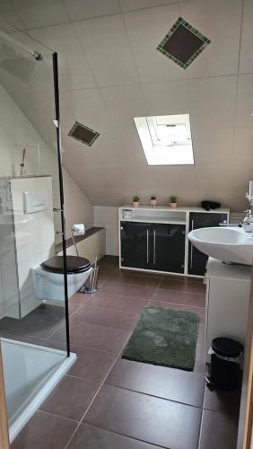 a bathroom with a toilet and a sink at Ferienwohnung Monika in Hammelburg