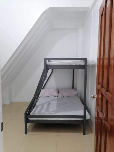 a bunk bed in a room with a staircase at RYO3 in Davao City