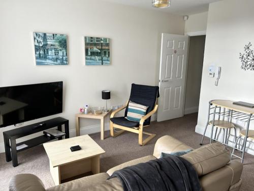 a living room with a couch and a tv at Norton Serviced Apartments in Stockton-on-Tees