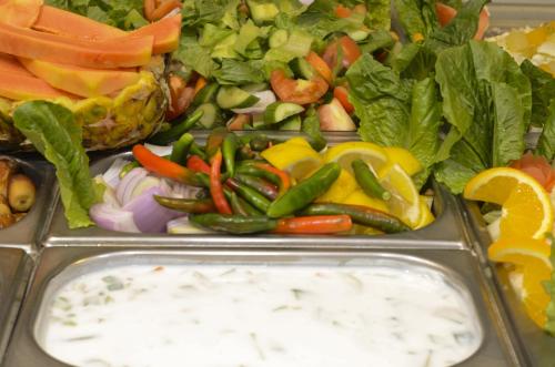 a tray of vegetables with a salad and dip at Royal Prince Hotel in Dubai
