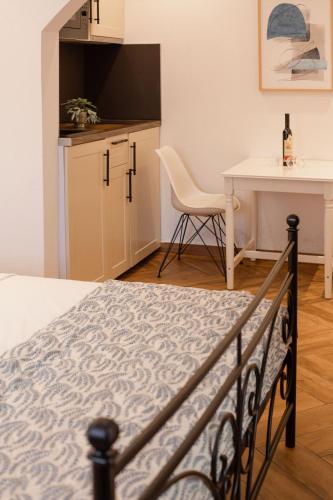 a bedroom with a bed and a desk and a table at Step to Kotor bay Perast in Perast