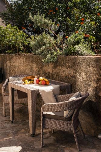 a table and chairs with a plate of fruit on it at Step to Kotor bay Perast in Perast