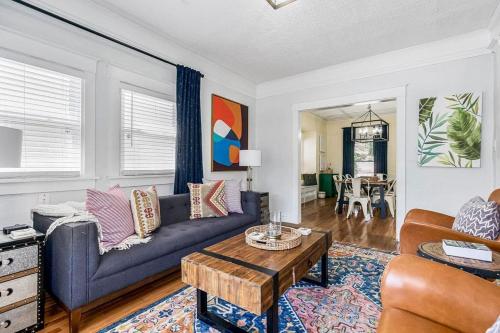 a living room with a couch and a table at Modern Comfort in Historic Charm: 4BR KC Retreat in Kansas City