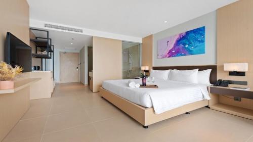 a large bedroom with a large bed and a television at THE CAM RANH RESORT at Bai Dai in Cam Ranh