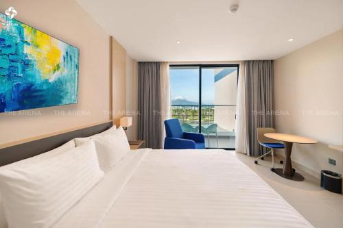 a hotel room with a bed and a desk and chair at THE CAM RANH RESORT at Bai Dai in Cam Ranh