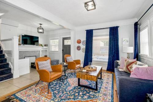 a living room with a couch and chairs and a table at Modern Comfort in Historic Charm: 4BR KC Retreat in Kansas City