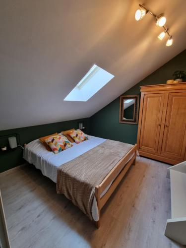 a bedroom with a bed and a skylight at Le Hourlay in Durbuy