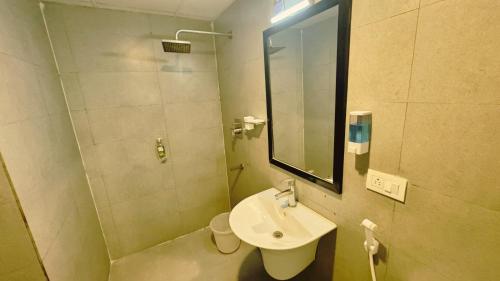 a small bathroom with a sink and a mirror at PHP BOUTIQUE TOWNHOUSE in Chennai