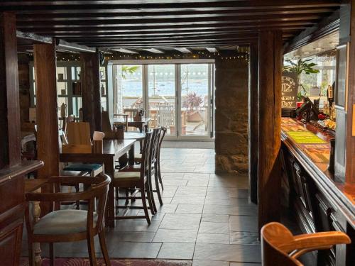 The Atlantic في Hugh Town: غرفة طعام مع طاولة وكراسي في مطعم