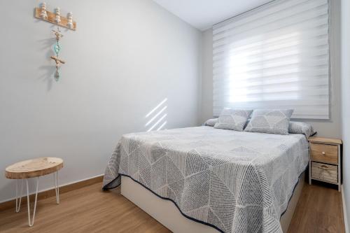 Ένα ή περισσότερα κρεβάτια σε δωμάτιο στο Apartamentos Cunidor - Cunit