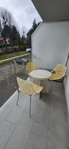 a table and chairs sitting on a balcony at 28 Dominikana in Sianozety