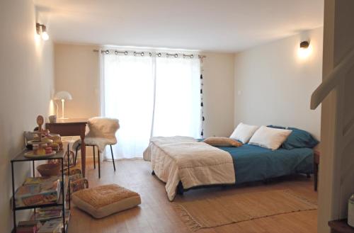 une chambre avec un lit, un bureau et une fenêtre dans l'établissement La Pause du Savoir Albigeois - Garage - Climatisation - Centre ville, à Albi