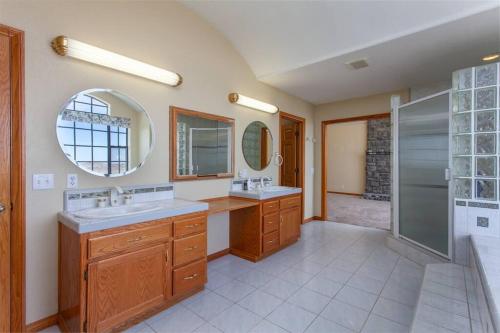 a bathroom with two sinks and a shower at LUXURIOUS VILLA FOR BEST VACATIONS AND MEMORIES in Palmdale