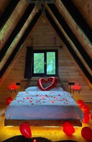 a bedroom with a heart shaped bed in a attic at Elmalook Bungalov & Tatil Köyü in Rize