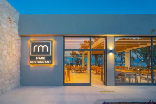 a building with a sign that says m make restaurant at Regia Mare Beach Hotel & Spa Bodrum in Ortakent