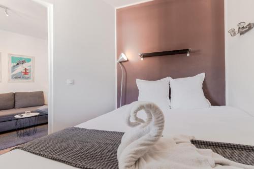 Cette chambre comprend un lit avec un cygne. dans l'établissement Le Balcon du Brevent - Central - Vue montagne, à Chamonix-Mont-Blanc