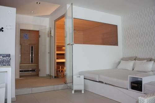 a bedroom with a bed and a sliding glass door at Seehotel Europa Resort in Velden am Wörthersee
