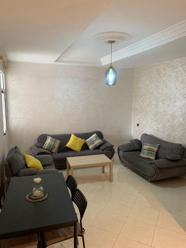 a living room with a couch and a table at cozy appartement meublé in Tangier