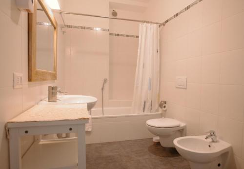 a bathroom with a sink and a toilet and a tub at Griante suites in Griante Cadenabbia