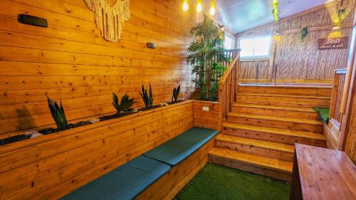 a sauna with wooden walls and benches and plants at bali carmel zimmer & spa in Dāliyat el Karmil