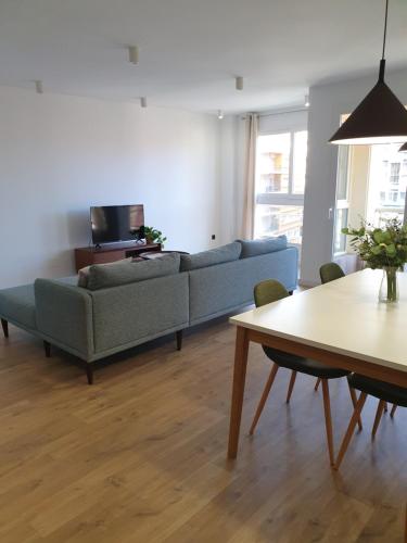 a living room with a couch and a table at LaRambla Alicante City 3 Bdrm in Alicante