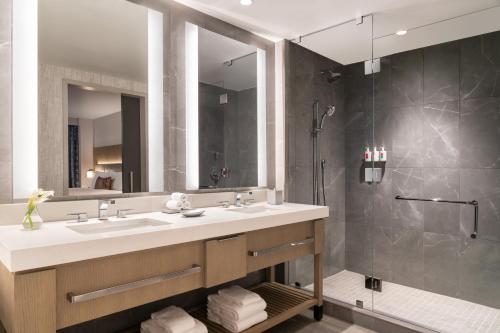 a bathroom with a sink and a shower at Loews Arlington Hotel in Arlington