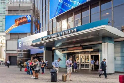 a group of people standing outside of a building at Sage Stay by the Train, We Pay Half Your Parking, 2 Queen Beds plus Sleeps 6 in Hoboken