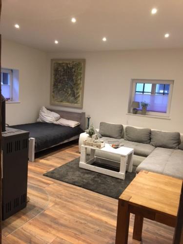 a living room with a couch and a table at Cottage in Nüchel