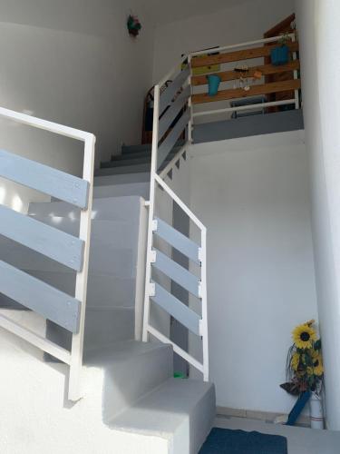 a white staircase with a bunk bed in a room at Apartment Domi in Starigrad