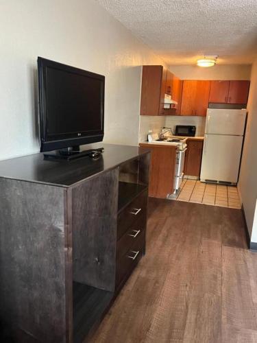 a kitchen with a flat screen tv on a counter at Days Inn & Suites by Wyndham Monroe in Monroe