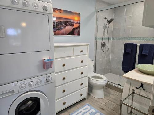 a bathroom with a washing machine and a shower at Seahorse - Tiny Home 1.2 Mi, 2 Beach Kitchen W & D Queen Bed in Bonita Springs
