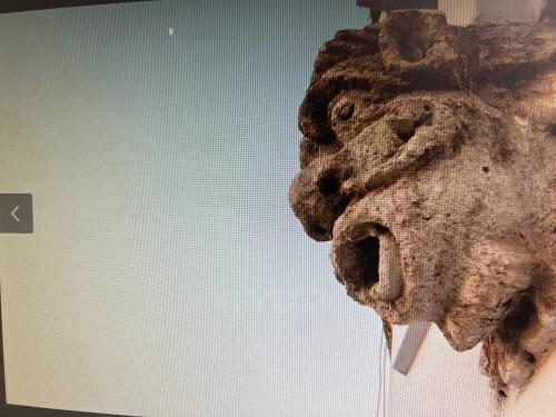 a statue of a lion head on the side of a building at Nicanto Rooms in Taranto