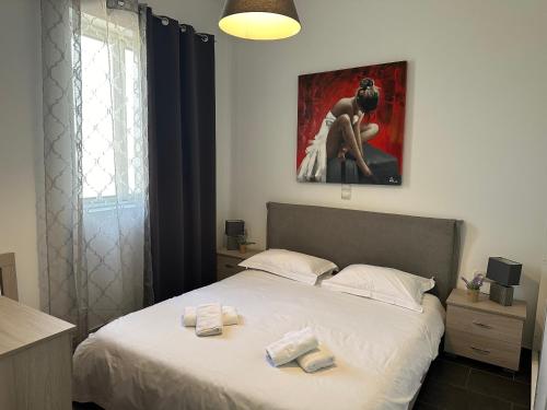 a bedroom with a bed with a painting on the wall at Renovated flat with Acropolis view in Athens