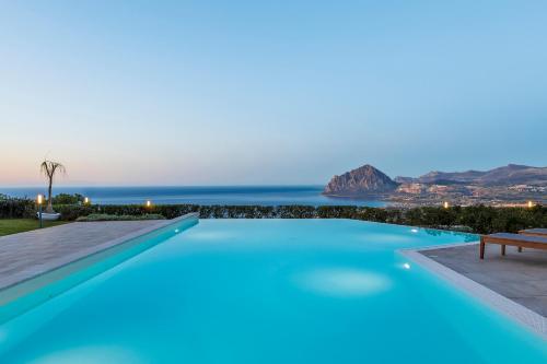 a swimming pool with a view of the ocean at Hotel Venere di Erice Resort & Spa in Valderice