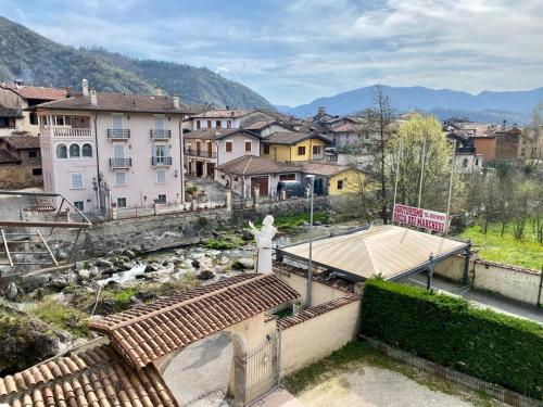 a view of a town with a statue and a river at Agriturismo Rocca Dei Marchesi in Sabbio Chiese