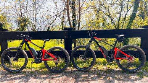 two bikes are parked next to a fence at Asolo Norah's Hill Agri Rooms in Caenere