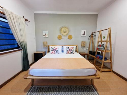 a bedroom with a bed and a ladder in it at Aya Beach Resort in Kizimkazi