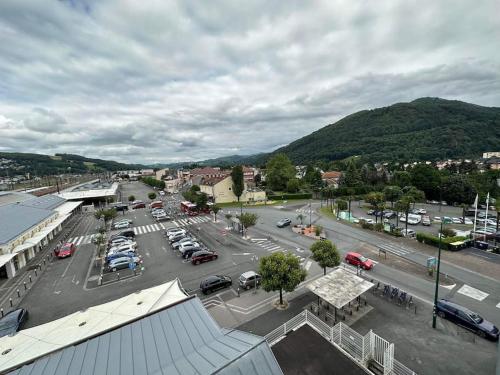 an aerial view of a parking lot in a town at Le Cocon - proche gare et centre ville in Lourdes