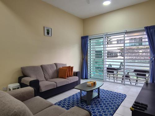 a living room with a couch and a table at The Simplicity Homestay in Tanah Rata