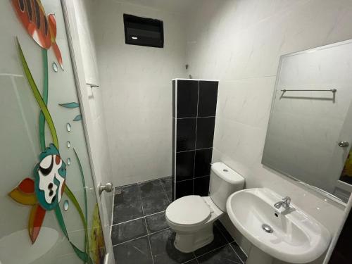 a bathroom with a toilet and a sink at บ้านพูลทรัพย์วิลเลจ POONSUB VILLAGe in Ban Na Charoen