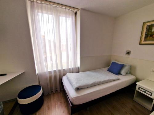 a small room with a bed with a large window at Plaza in Kreuzlingen