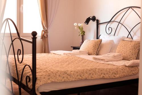 a bedroom with a bed with a wrought iron frame at Step to Kotor bay Perast in Perast