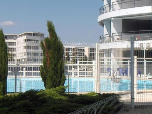 a pool on a cruise ship with buildings in the background at résidence lac de La Sole T3 4 pers les minimes avec piscine in La Rochelle