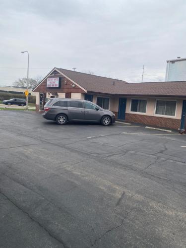 a car parked in a parking lot in front of a building at COURTESY MOTEL in Urbana
