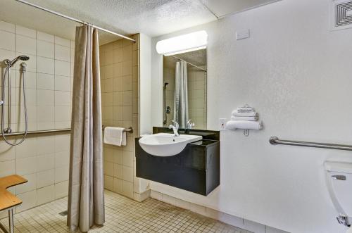 a bathroom with a sink and a mirror at Motel 6-Pittsburgh, PA - Crafton in Pittsburgh