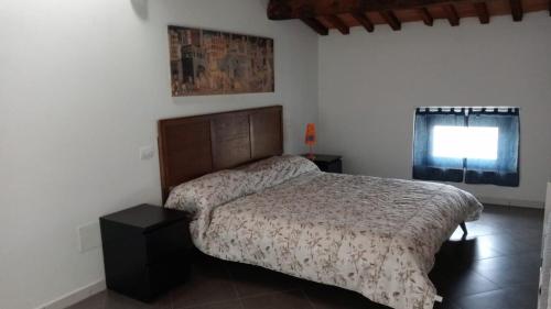 a bedroom with a bed and a window at Lucky House Pisa in Cascina